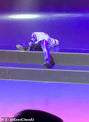 Humanoid robot stumbles over stage step during public dance performance.